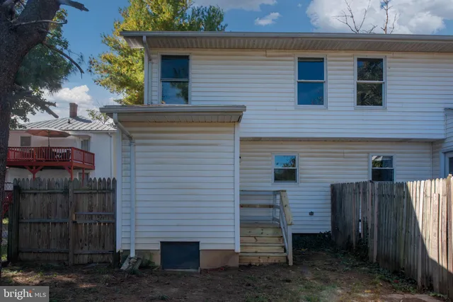 a view of a room with wooden floor and window