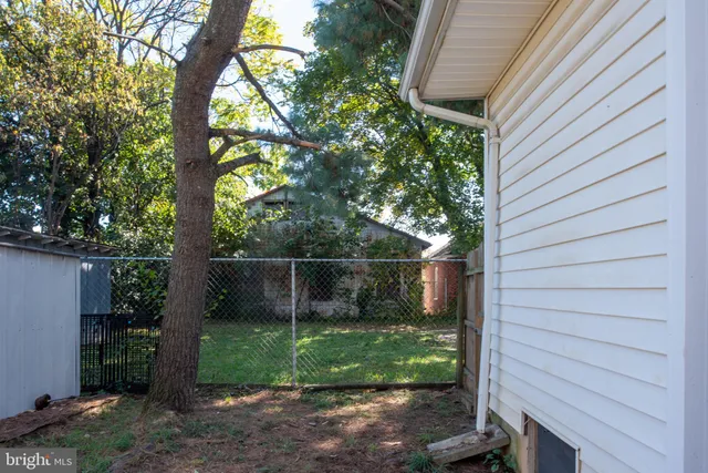 a bathroom with a granite countertop bathtub shower sink vanity and toilet