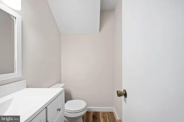 a kitchen with stainless steel appliances granite countertop a refrigerator sink and white cabinets