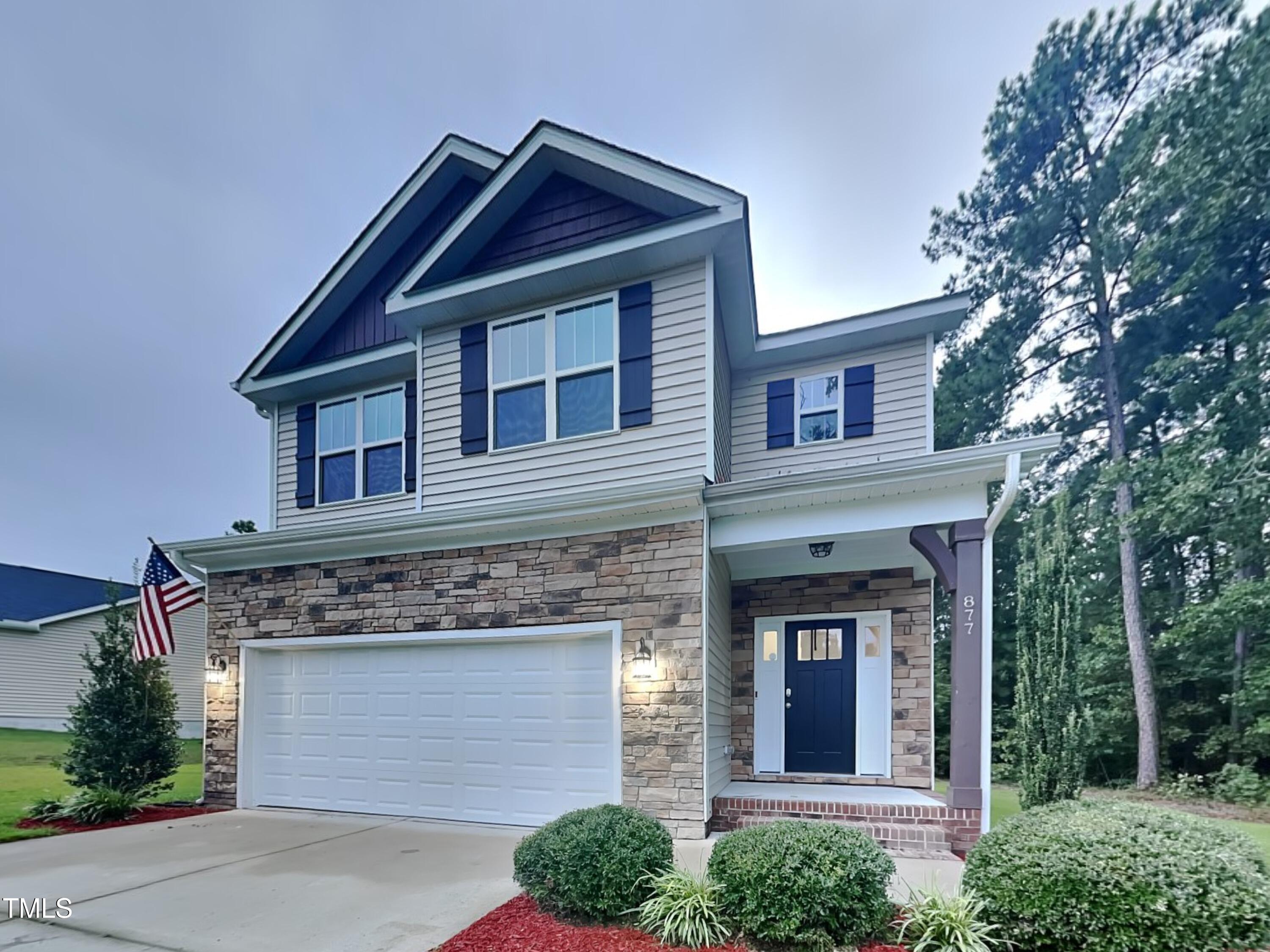 877 Juno Drive Broadway, NC 27505 - Photo 1 of 22 a front view of a house with a garden