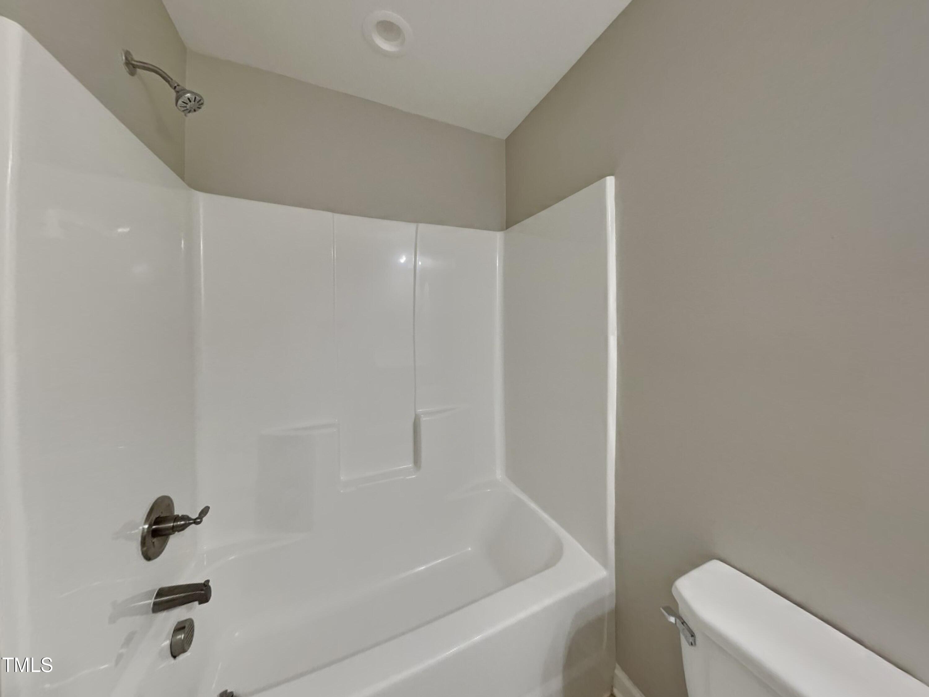 877 Juno Drive Broadway, NC 27505 - Photo 19 of 22 a bathroom with a bathtub and toilet