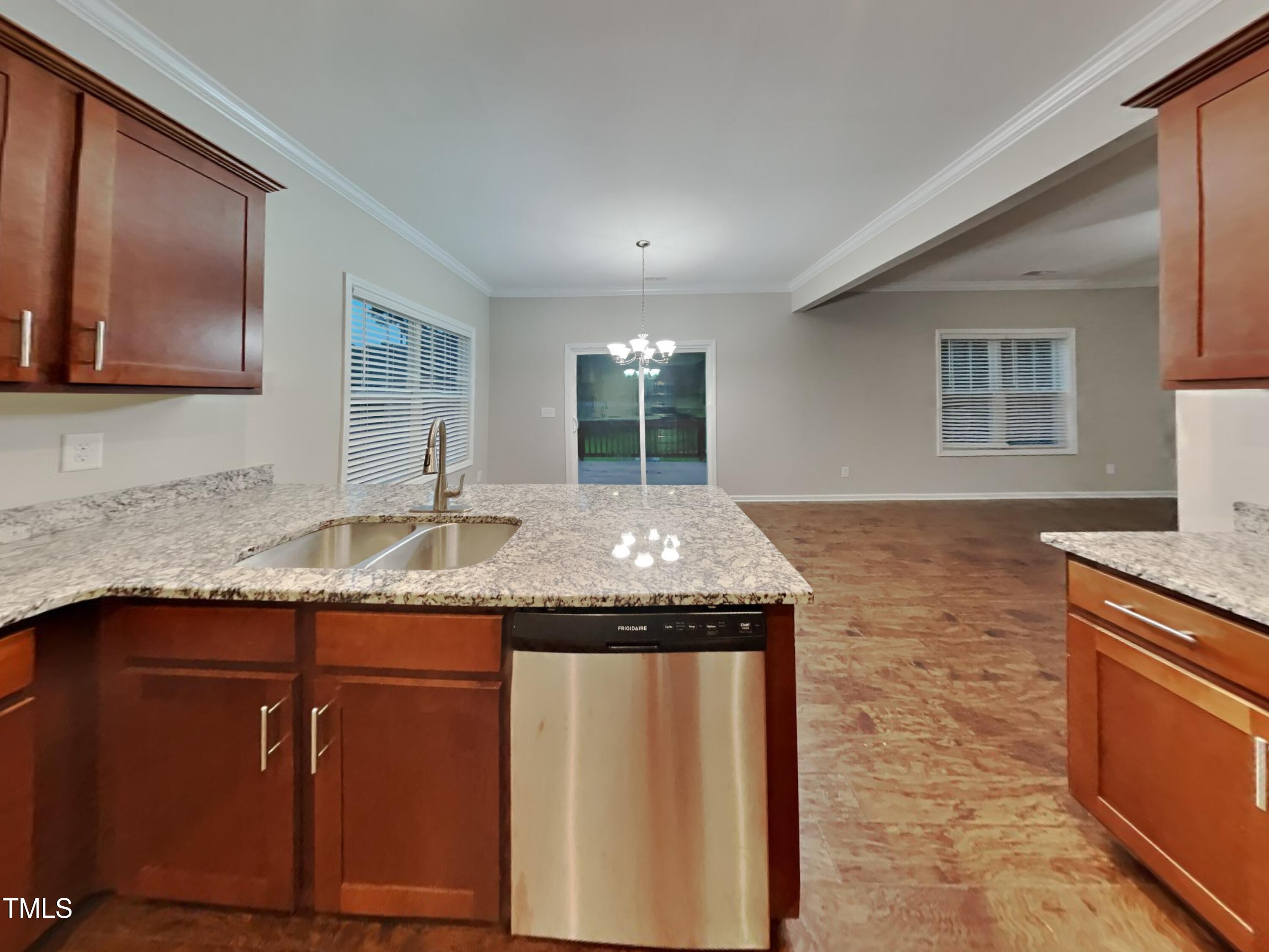877 Juno Drive Broadway, NC 27505 - Photo 6 of 22 a kitchen with granite countertop sink stove and cabinets