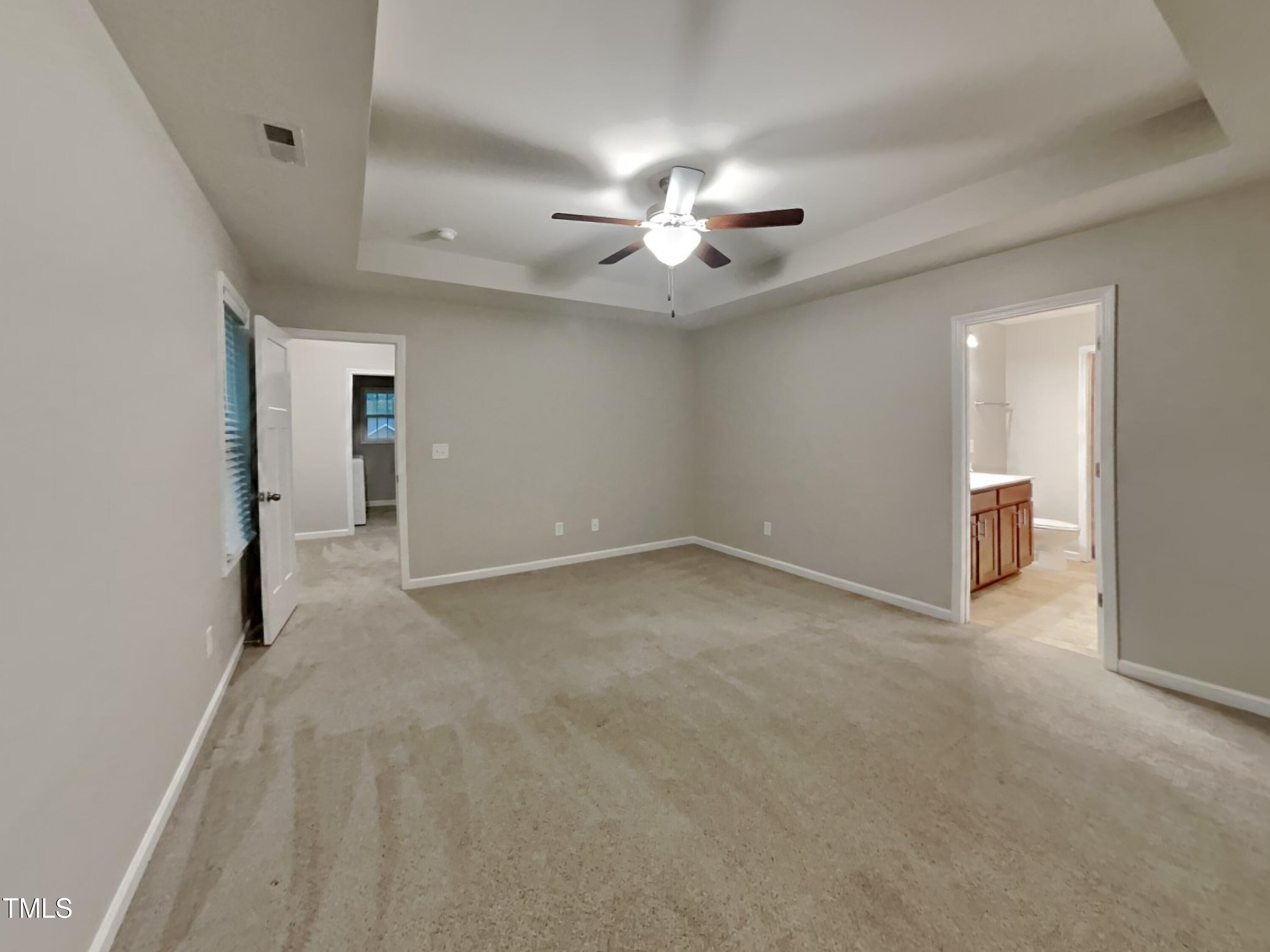 877 Juno Drive Broadway, NC 27505 - Photo 8 of 22 an empty room with chandelier fan and windows