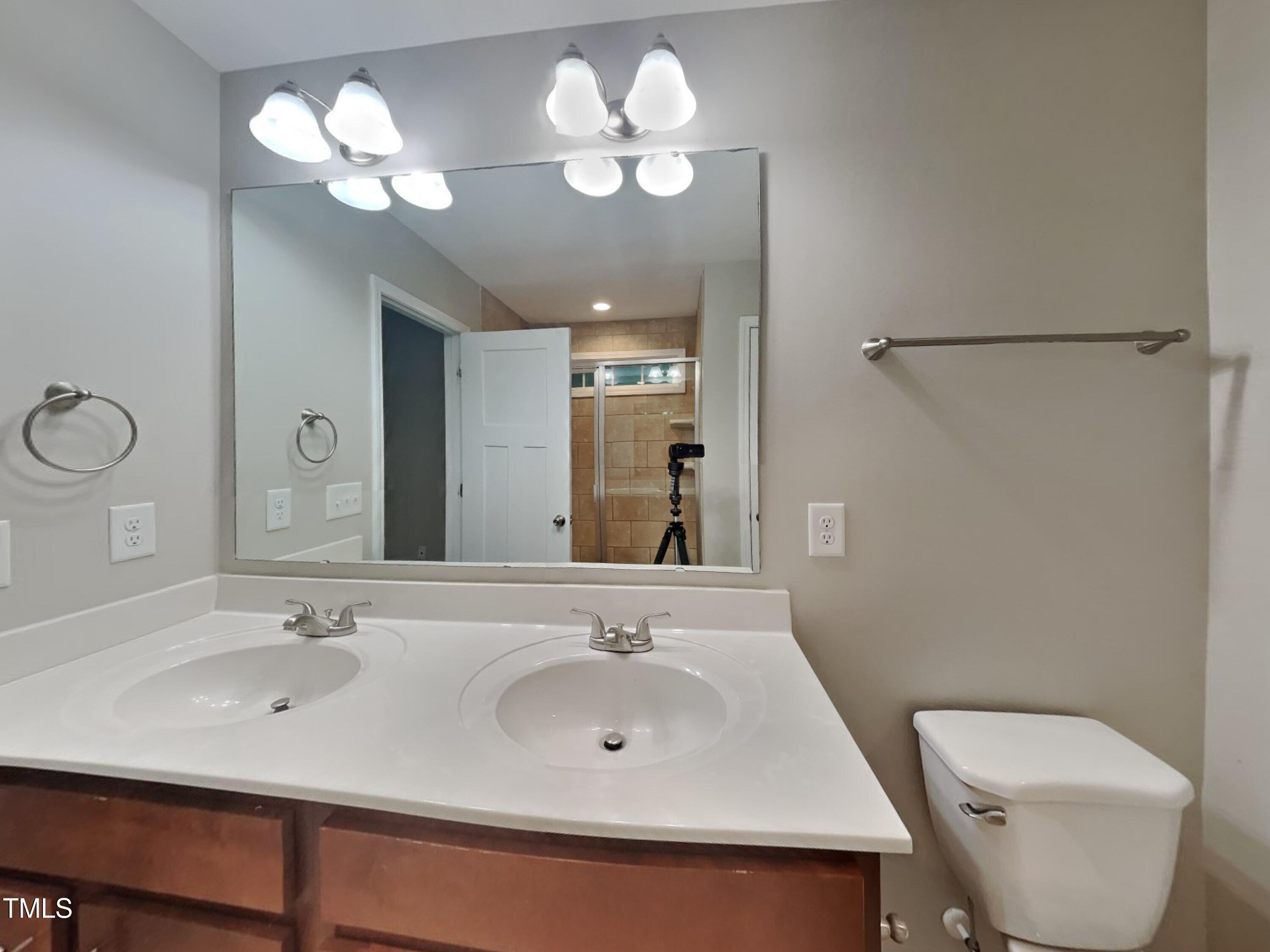 877 Juno Drive Broadway, NC 27505 - Photo 9 of 22 a bathroom with a sink and a mirror