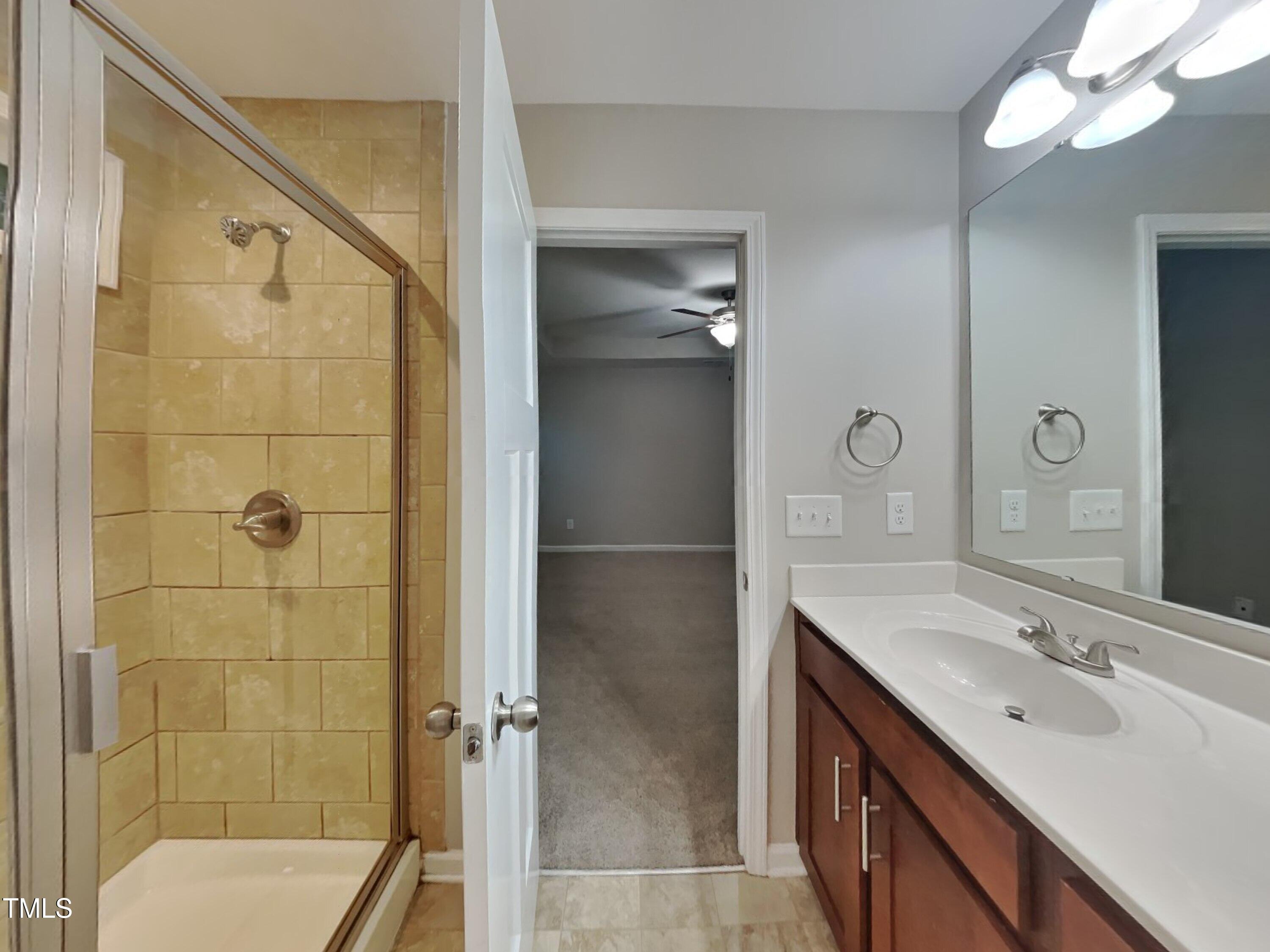 877 Juno Drive Broadway, NC 27505 - Photo 10 of 22 a bathroom with a double vanity sink mirror and shower