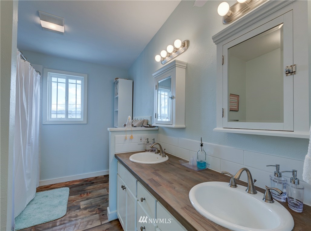 2575 West Beach Road Oak Harbor, WA 98277 - Photo 17 of 25 a bathroom with a sink double vanity and a mirror