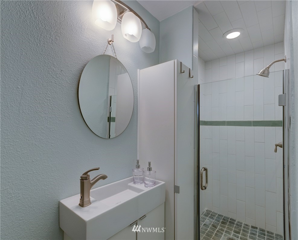 2575 West Beach Road Oak Harbor, WA 98277 - Photo 9 of 25 a bathroom with a sink a mirror and a shower