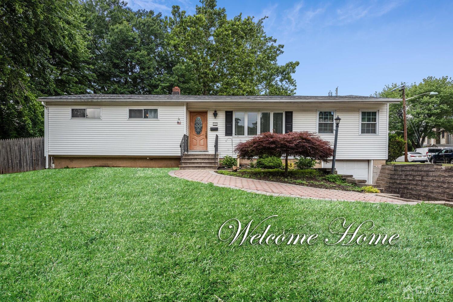 28 Brookside Road Edison, NJ 08817 - Photo 1 of 1 a front view of a house with a garden and yard
