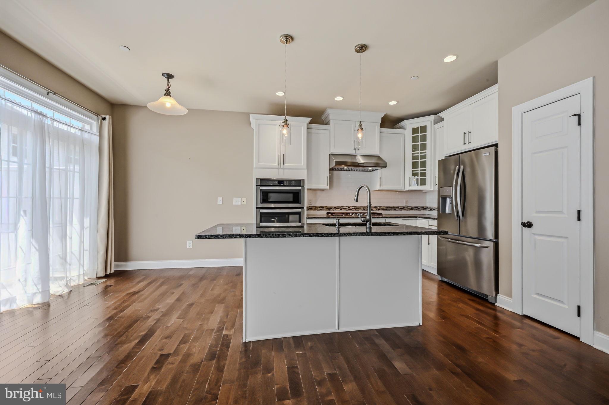 208 Jackdaw Alley, Unit 208 Springfield, PA 19064 - Photo 15 of 49 a kitchen with stainless steel appliances a refrigerator sink and microwave