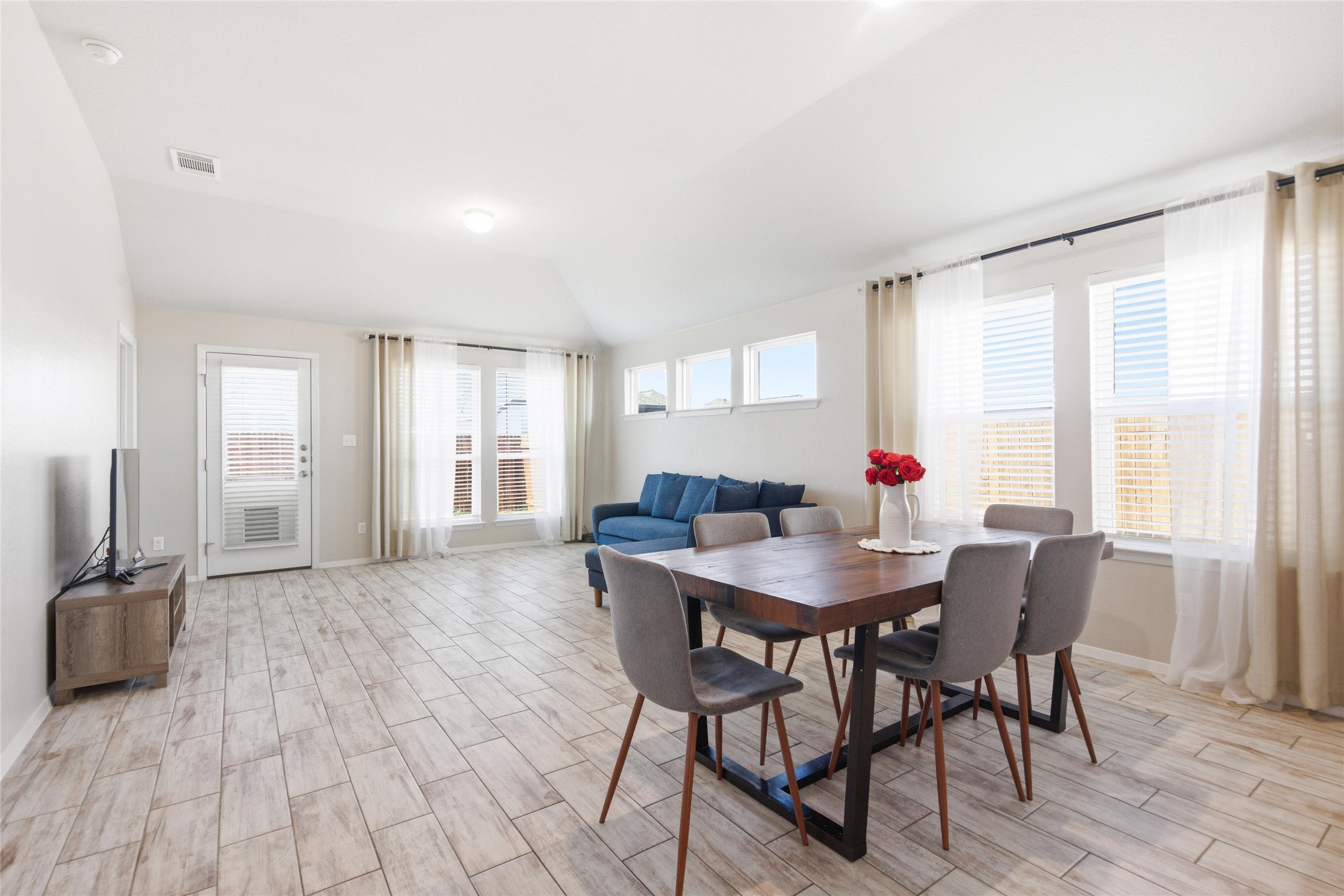 269 Gaida Loop Georgetown, TX 78628 - Photo 8 of 20 Dining area featuring lofted ceiling and wood tiled floors
