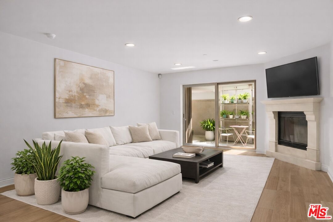 a living room with furniture fireplace and flat screen tv