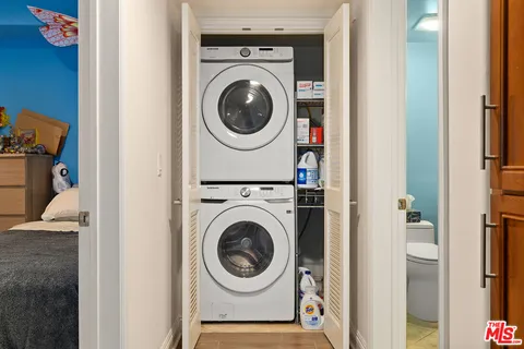 a view of a bedroom with washer and dryer