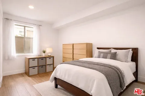 a spacious bedroom with a bed and window