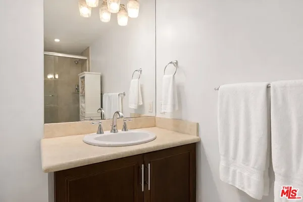 a bathroom with double sink and a mirror