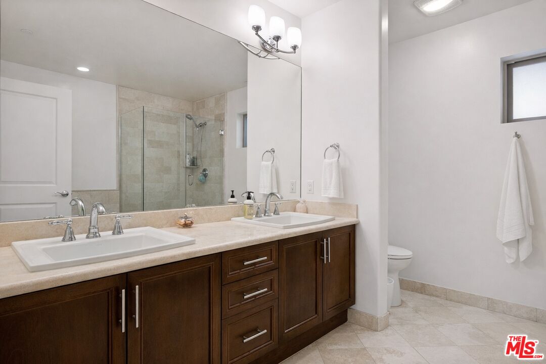8238 West Manchester Avenue, Unit 108 Playa del Rey, CA 90293 - Photo 10 of 16 a bathroom with a double vanity sink and a mirror