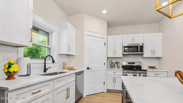 a kitchen with stainless steel appliances a sink stove and refrigerator