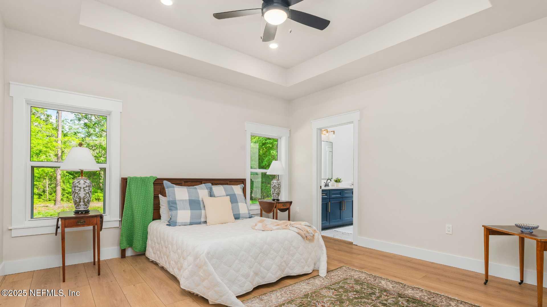 10055 Fox Hollow Drive Hampton, FL 32044 - Photo 16 of 54 a bedroom with a large bed and a window