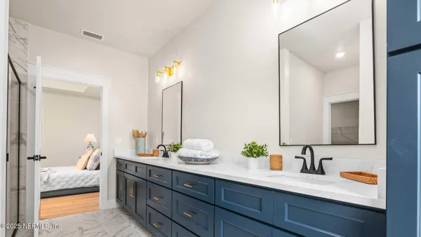 a bathroom with a double vanity sink and a mirror