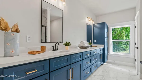 a bathroom with a sink mirror and vanity