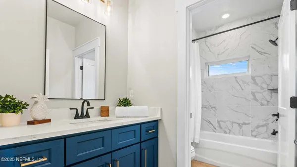 a bathroom with a toilet and a tub