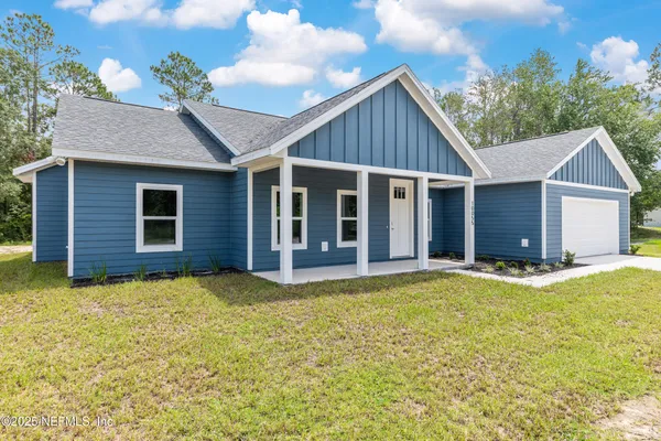 a view of a house with a yard and garage