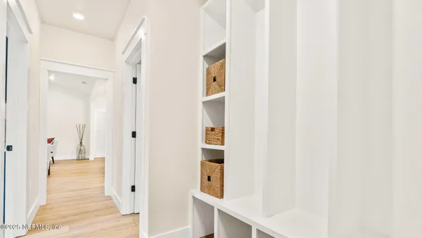 a view of wooden floor and cabinets in a kitchen