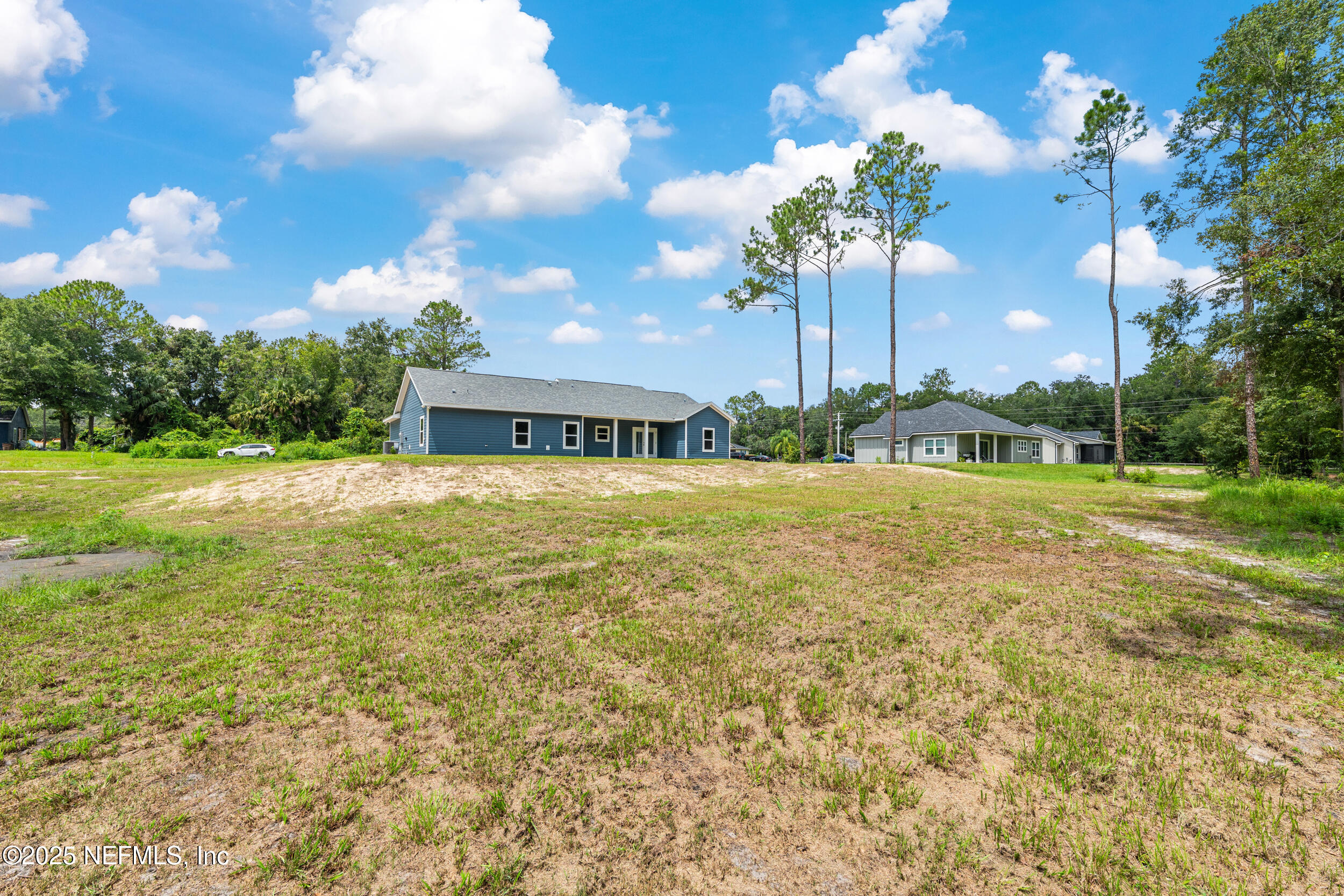 10055 Fox Hollow Drive Hampton, FL 32044 - Photo 43 of 54 a house view with swimming pool and trees in the background