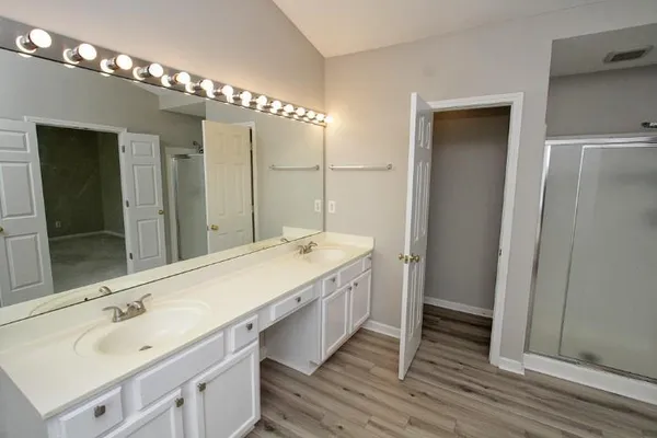 a bathroom with a double vanity sink and a mirror