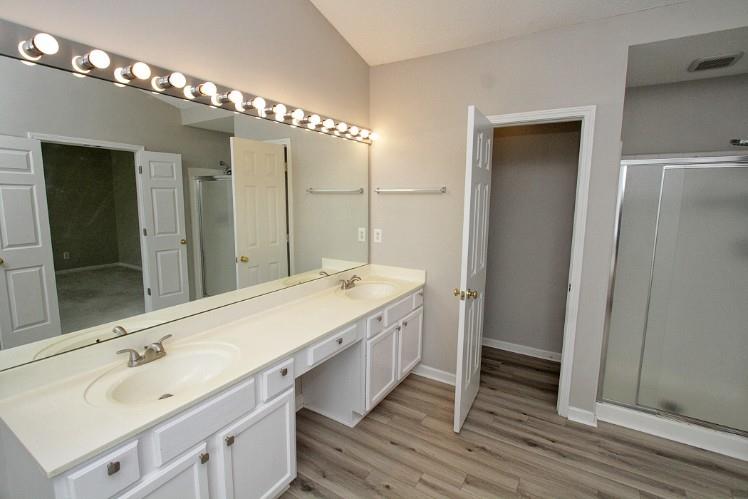 11700 Bentham Court Alpharetta, GA 30005 - Photo 13 of 21 a bathroom with a double vanity sink and a mirror