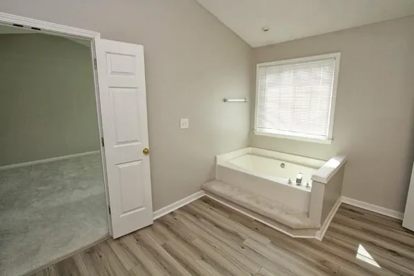 a bathroom with a tub a sink and a shower