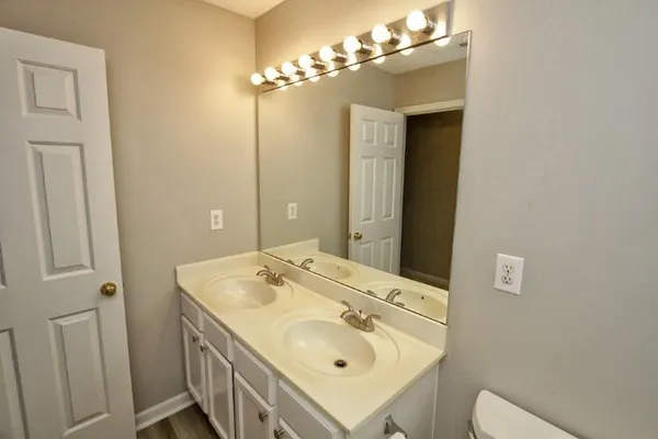 a bathroom with a bath tub with a toilet and a shower