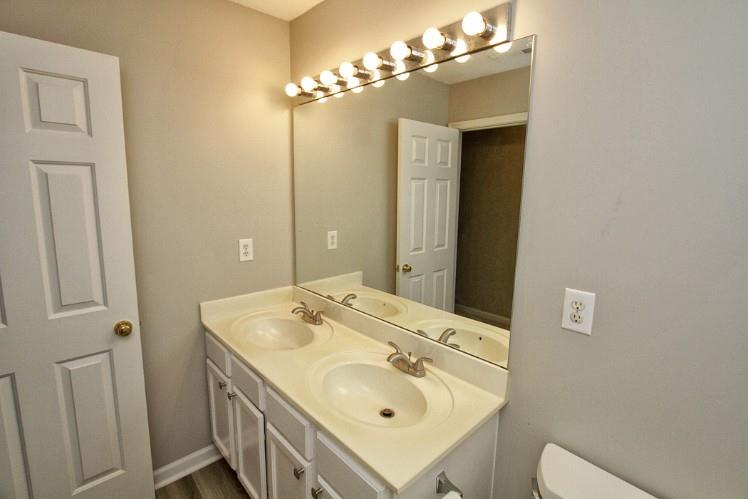 11700 Bentham Court Alpharetta, GA 30005 - Photo 17 of 21 a bathroom with a sink a light fixture and a mirror