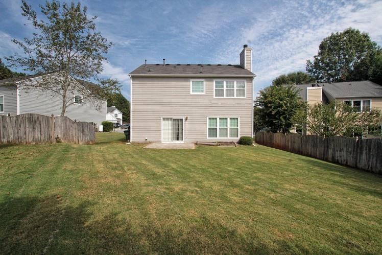 11700 Bentham Court Alpharetta, GA 30005 - Photo 20 of 21 a view of a house with a yard