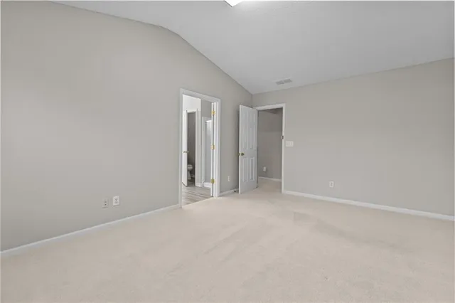 a spacious bathroom with a granite countertop sink mirror and cabinets