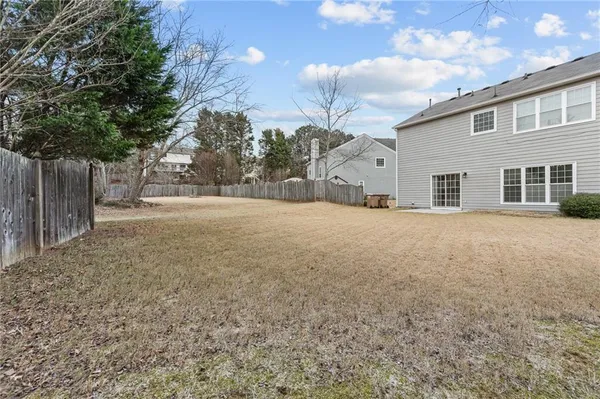 a view of a house with a yard covered in snow