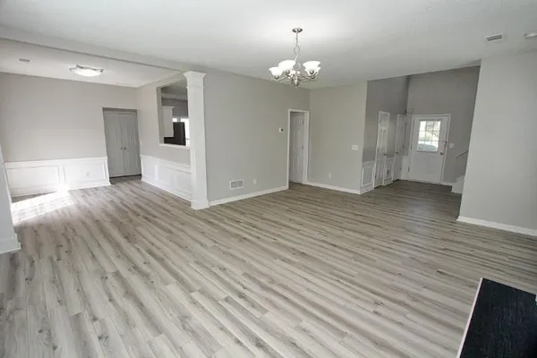 a view of an empty room and wooden floor