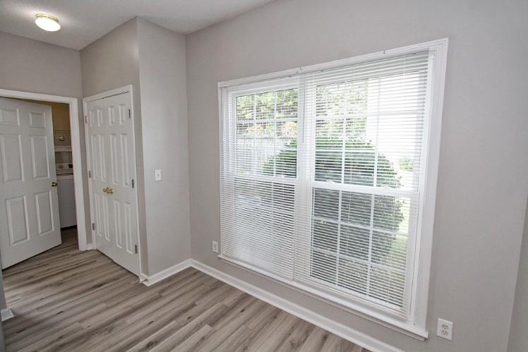 11700 Bentham Court Alpharetta, GA 30005 - Photo 6 of 21 a view of empty room with wooden floor and fan