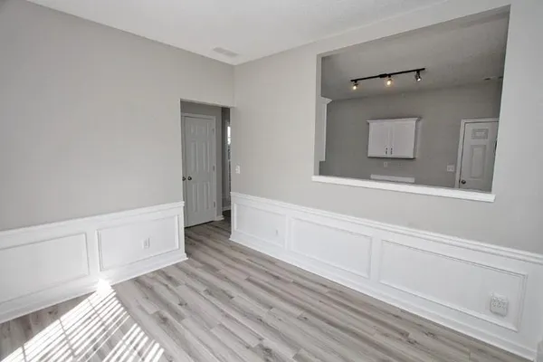 a view of a livingroom with wooden floor and cabinet