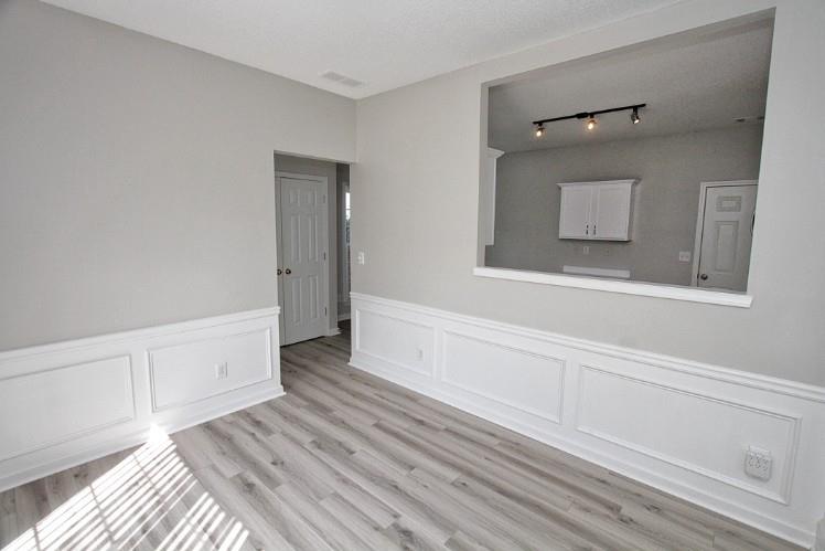11700 Bentham Court Alpharetta, GA 30005 - Photo 8 of 21 a view of a livingroom with wooden floor and cabinet