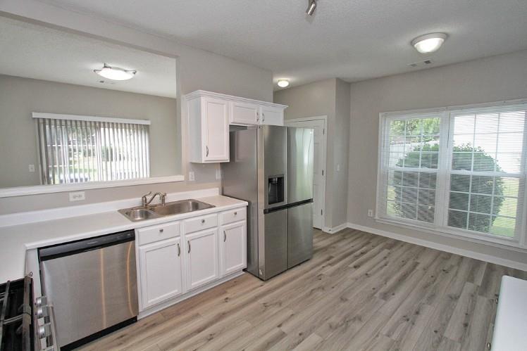 11700 Bentham Court Alpharetta, GA 30005 - Photo 9 of 21 a kitchen with a sink a refrigerator and window