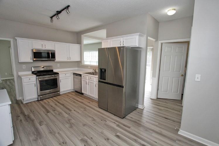 11700 Bentham Court Alpharetta, GA 30005 - Photo 10 of 21 a kitchen with stainless steel appliances a refrigerator sink and microwave