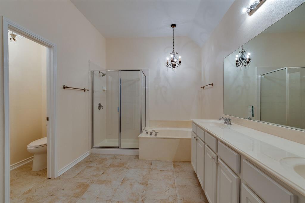7728 Lancaster Gate Frisco, TX 75035 - Photo 10 of 30 a spacious bathroom with a shower sink and a mirror