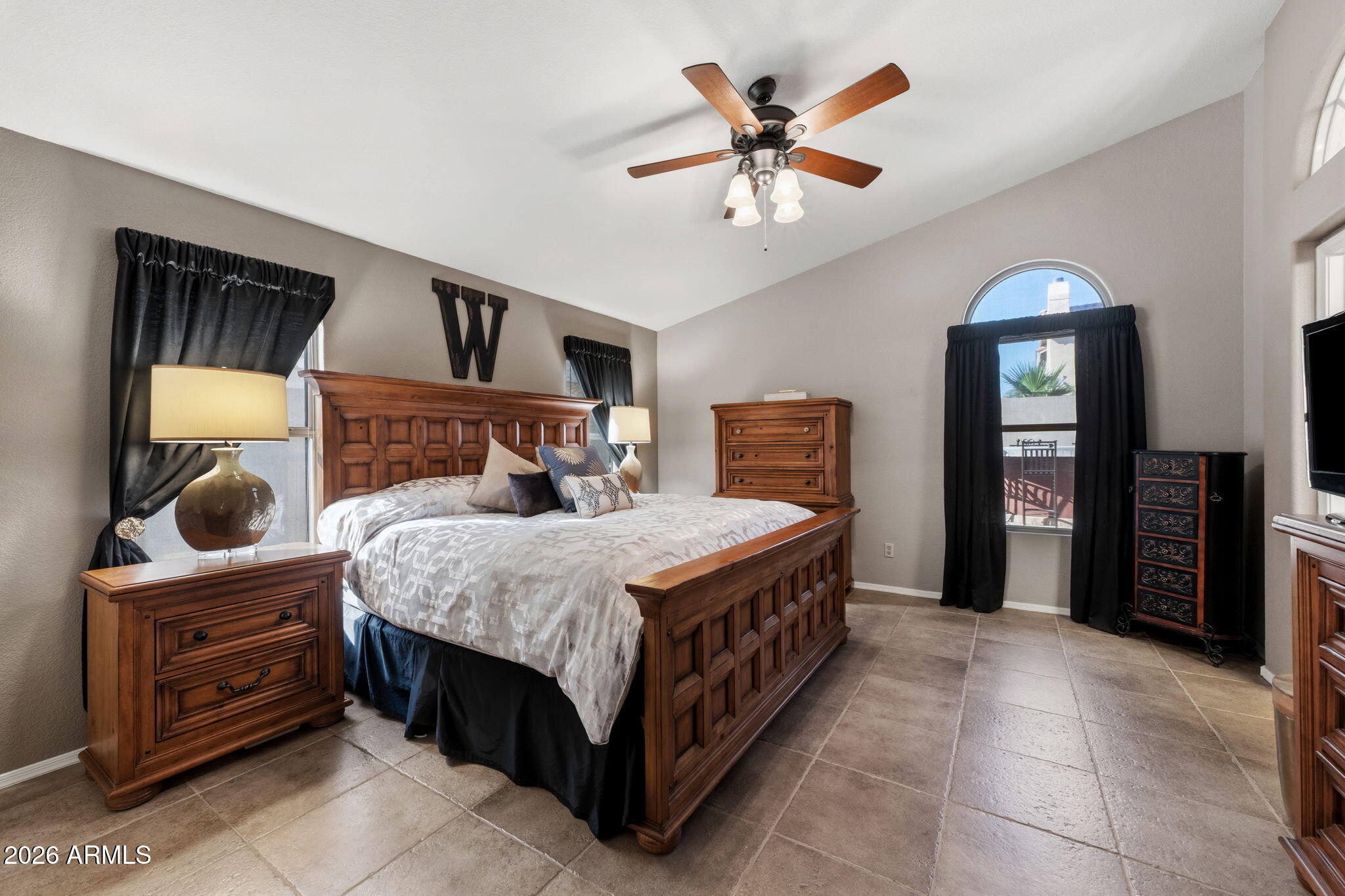 6526 East Raftriver Street Mesa, AZ 85215 - Photo 7 of 17 a bedroom with a large bed and a chandelier