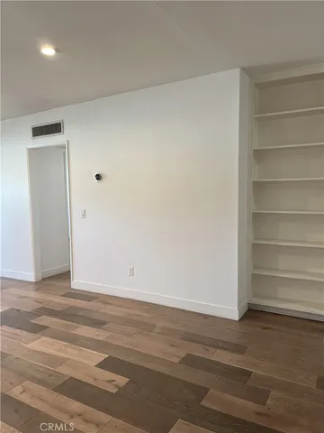 a view of a room with wooden floor