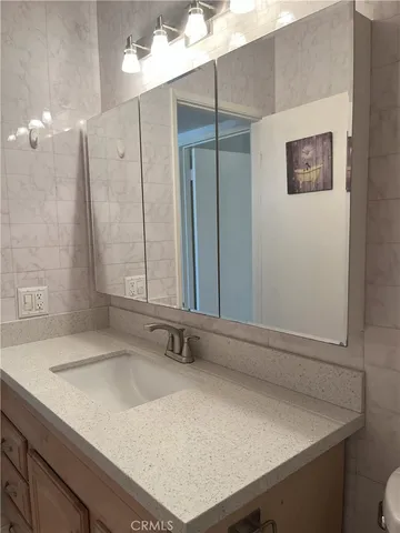 a view of a small space with wooden floor and a window