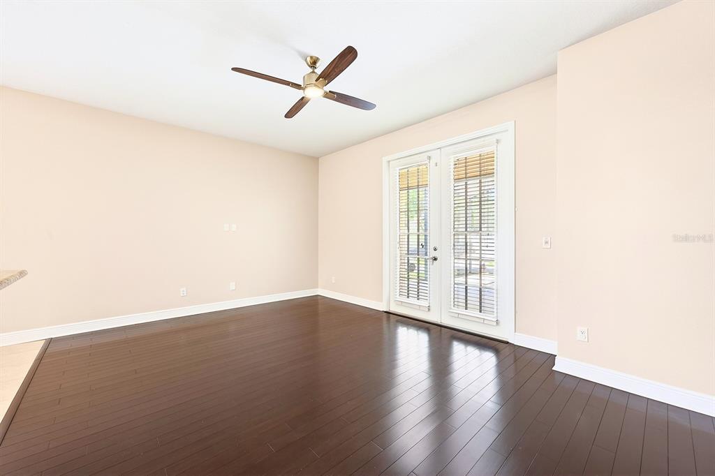 918 Seburn Road Apopka, FL 32703 - Photo 12 of 34 an empty room with wooden floor fan and windows