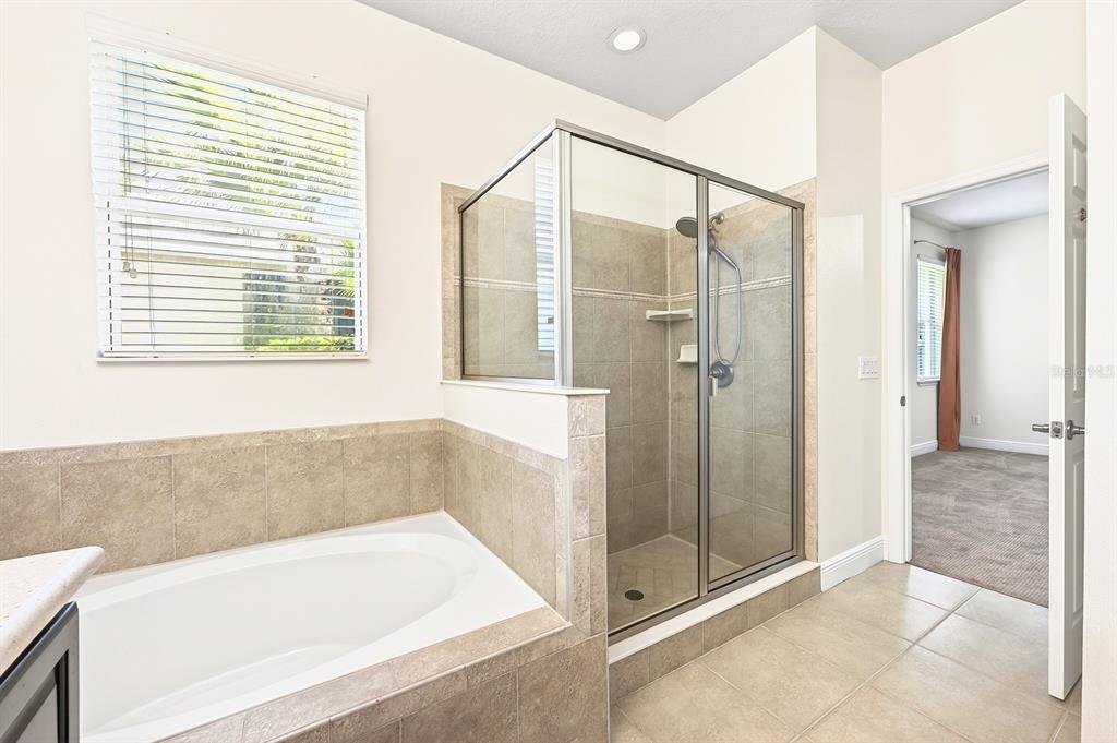 918 Seburn Road Apopka, FL 32703 - Photo 16 of 34 a bathroom with a bathtub and a shower
