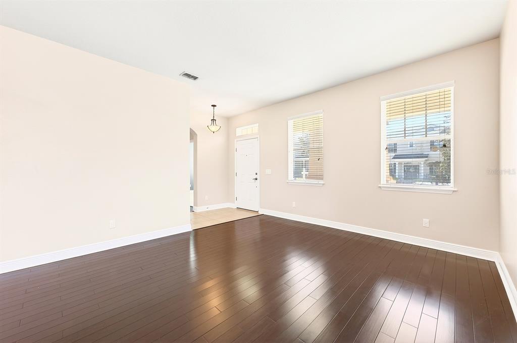918 Seburn Road Apopka, FL 32703 - Photo 3 of 34 an empty room with wooden floor and windows