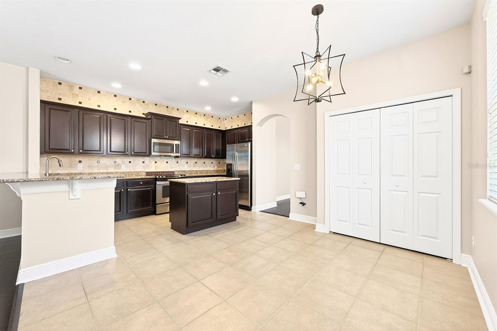 918 Seburn Road Apopka, FL 32703 - Photo 6 of 34 a kitchen with stainless steel appliances granite countertop a stove a sink a refrigerator and a granite counter tops