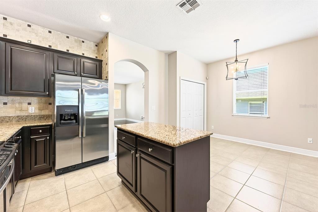 918 Seburn Road Apopka, FL 32703 - Photo 9 of 34 a kitchen with stainless steel appliances granite countertop a refrigerator a sink and dishwasher